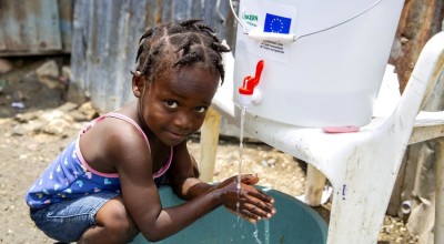Cherica (2) washes her hands in front of her grandmother's home in Cite Soleil, a district of Port-au-Prince, Haiti. Photo: Dieu Nalio Chery/ Concern Worldwide