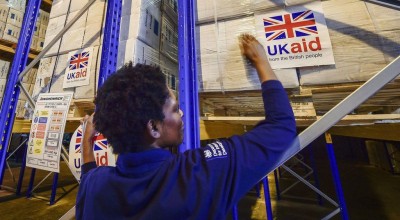A woman prepares to send a shipment of suppoprt provided by UK aid