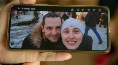 Sofia looking at pictures of her life in Ukraine.She has had to leave her job as a nurse, her husband and extended family behind. Sofia and her son fled from Ukraine to Romania. With no money or anywhere to go, they have been living of the kindness of strangers to get by.
