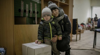 Darina* and her young son, Petro* with their food kit.