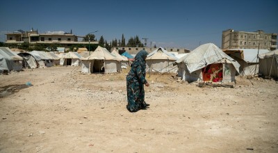Shahinaz* walks through a camp in northwest Syria. As part of Concern's DEC funded response to the Syria-Turkey earthquakes, cash assistance is distributed to displaced families living in camps and temporary shelters to meet their immediate basic needs.