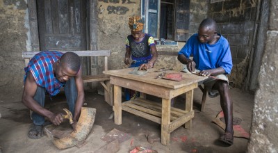 Assa Kamara, Marie Sasay and Isse Conteh fabricating eco stoves from scrap metal.