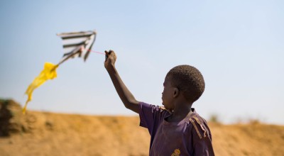 A child flies a home-made kite in a PoC camp in Juba, South Sudan. Photo: Steve De Neef / Concern Worldwide.