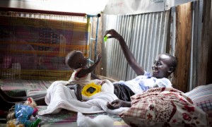 Dehlia* with her sister Koaloch* hang out in the mother and baby room in the Concern Worldwide Nutrition Clinic in a POC in Juba, South Sudan. Photo: Abbie Trayler-Smith